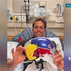 World champion surfer Kai Lenny holding his cracked helmet ''It may have saved my life''